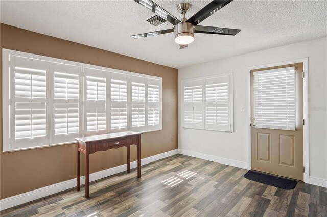 9622 Brassie Ct Unit 9, New Port Richey, FL 34655 - doorway to outside with ceiling fan, a textured ceiling, wood finished floors, and baseboards