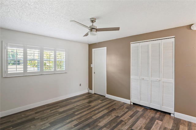 9622 Brassie Ct Unit 9, New Port Richey, FL 34655 - unfurnished bedroom featuring dark wood finished floors, a closet, baseboards, a textured ceiling, and a ceiling fan