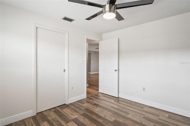 9622 Brassie Ct Unit 9, New Port Richey, FL 34655 - unfurnished bedroom featuring wood finished floors, baseboards, ceiling fan, and a closet