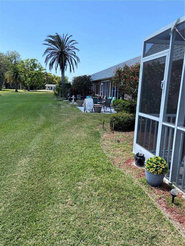 9622 Brassie Ct Unit 9, New Port Richey, FL 34655 - view of green lawn featuring a patio and a lanai
