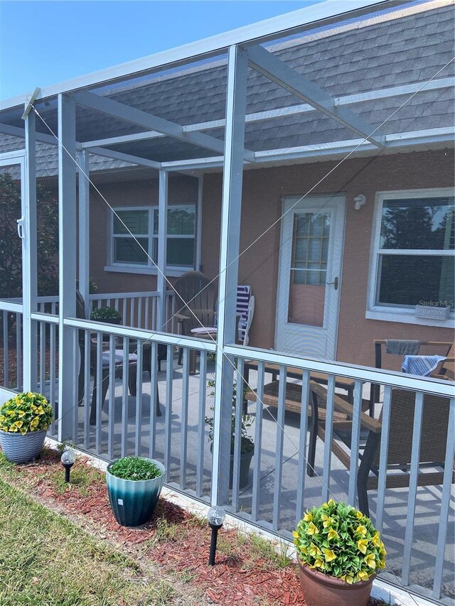 9622 Brassie Ct Unit 9, New Port Richey, FL 34655 - view of property exterior with a shingled roof and a lanai