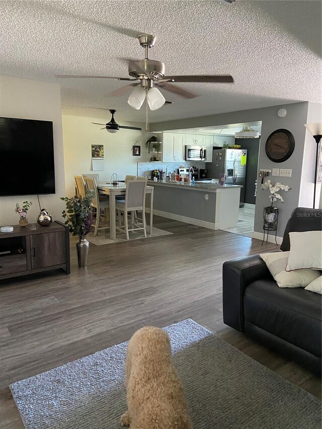9622 Brassie Ct Unit 9, New Port Richey, FL 34655 - living area with ceiling fan, wood finished floors, and a textured ceiling