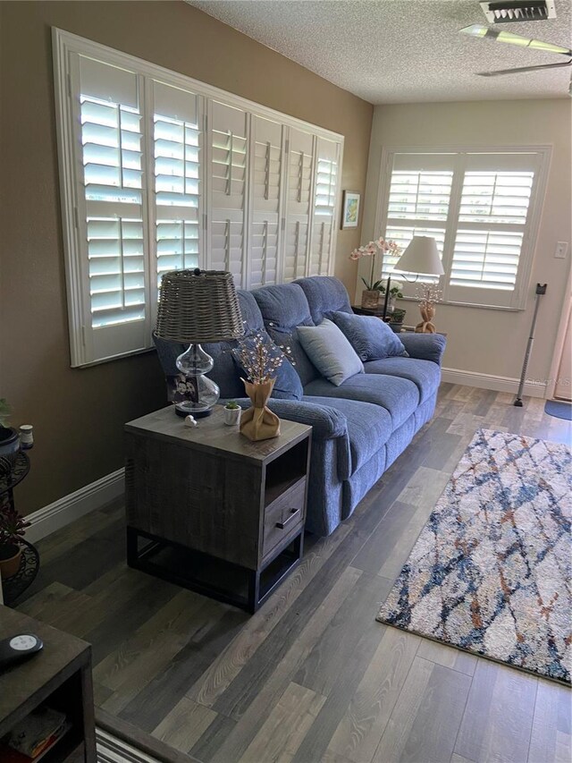 9622 Brassie Ct Unit 9, New Port Richey, FL 34655 - living room featuring wood finished floors, a textured ceiling, and baseboards