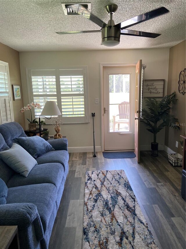 9622 Brassie Ct Unit 9, New Port Richey, FL 34655 - living room with a ceiling fan, a textured ceiling, light wood-style flooring, and baseboards
