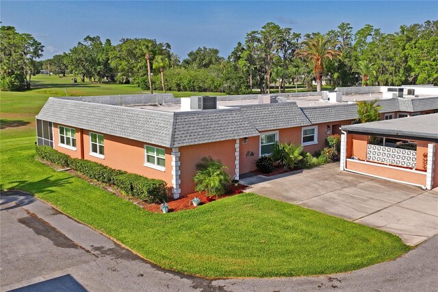 9622 Brassie Ct Unit 9, New Port Richey, FL 34655 - view of front of home featuring a front yard, central air condition unit, and view of scattered trees