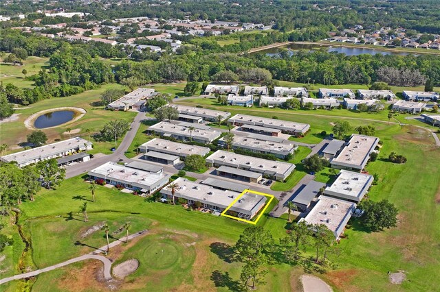 9622 Brassie Ct Unit 9, New Port Richey, FL 34655 - aerial view of property and surrounding area with a large body of water, nearby suburban area, a golf course, and a tree filled landscape