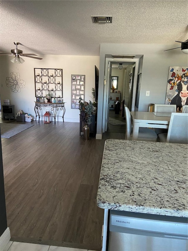 9622 Brassie Ct Unit 9, New Port Richey, FL 34655 - dining area with a ceiling fan, a textured ceiling, dark wood-type flooring, and baseboards