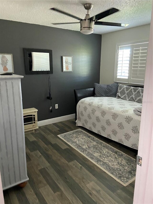9622 Brassie Ct Unit 9, New Port Richey, FL 34655 - bedroom with a textured ceiling, wood finished floors, a ceiling fan, and baseboards