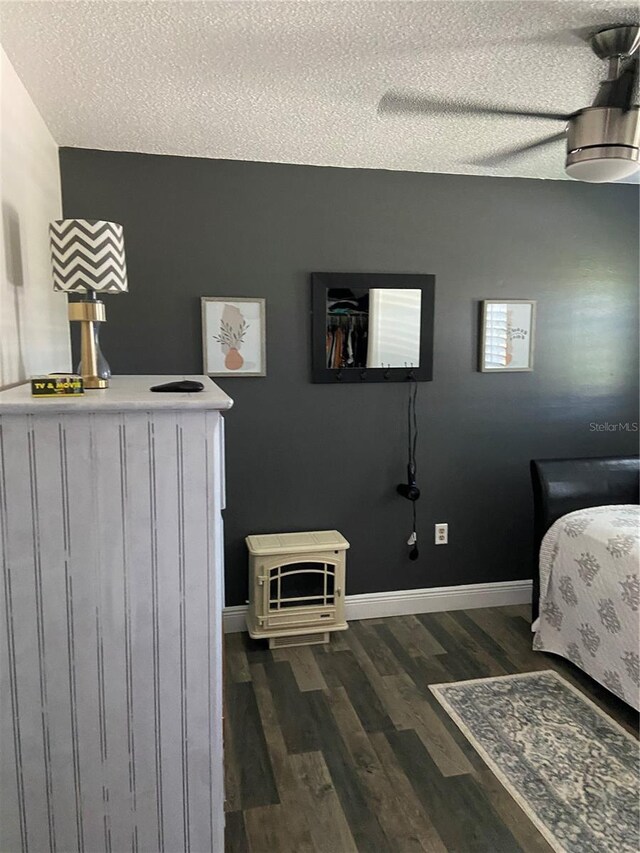 9622 Brassie Ct Unit 9, New Port Richey, FL 34655 - bedroom with a textured ceiling, dark wood finished floors, and baseboards