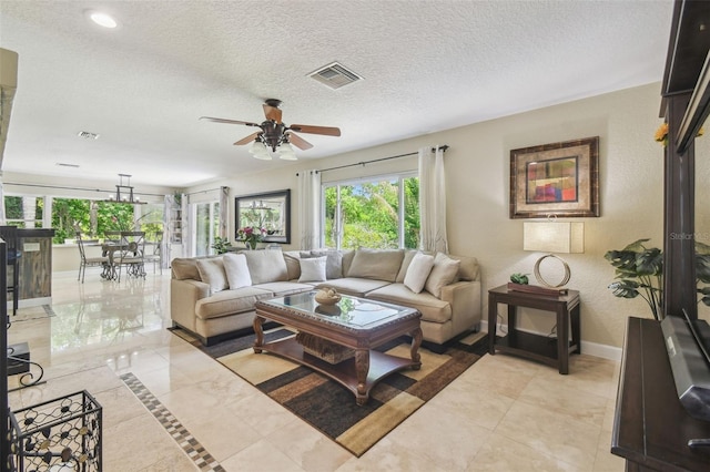 10301 Nina Ct, New Port Richey, FL 34654 - living room with ceiling fan, baseboards, a textured ceiling, and recessed lighting