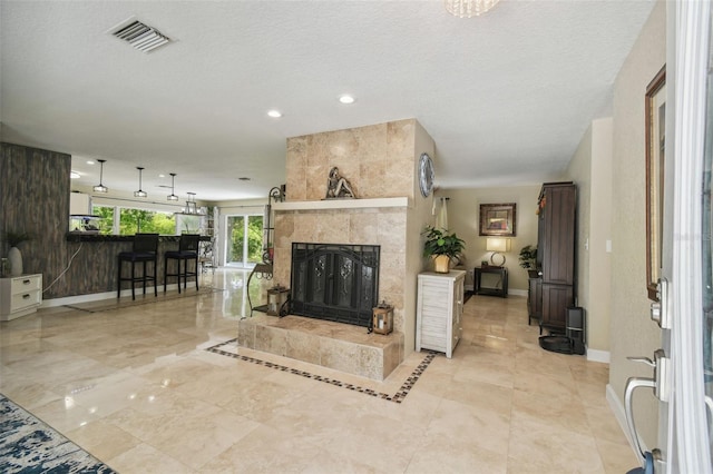 10301 Nina Ct, New Port Richey, FL 34654 - living room featuring baseboards, a fireplace, recessed lighting, and a textured ceiling