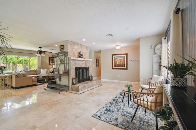 10301 Nina Ct, New Port Richey, FL 34654 - living room featuring a textured ceiling, a large fireplace, a ceiling fan, baseboards, and recessed lighting