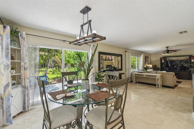 10301 Nina Ct, New Port Richey, FL 34654 - dining room with ceiling fan and a textured ceiling