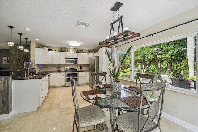 10301 Nina Ct, New Port Richey, FL 34654 - dining area with baseboards, light tile patterned floors, recessed lighting, and a textured ceiling