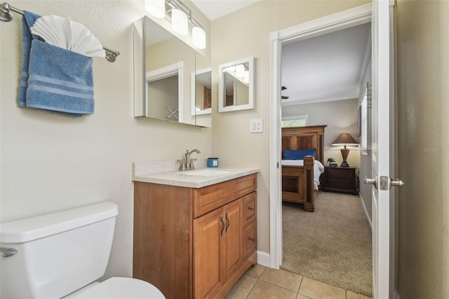10301 Nina Ct, New Port Richey, FL 34654 - ensuite bathroom with toilet, vanity, tile patterned floors, ornamental molding, and baseboards