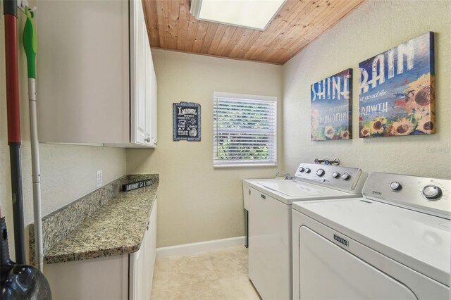 10301 Nina Ct, New Port Richey, FL 34654 - washroom with independent washer and dryer, cabinet space, light tile patterned flooring, baseboards, and wooden ceiling