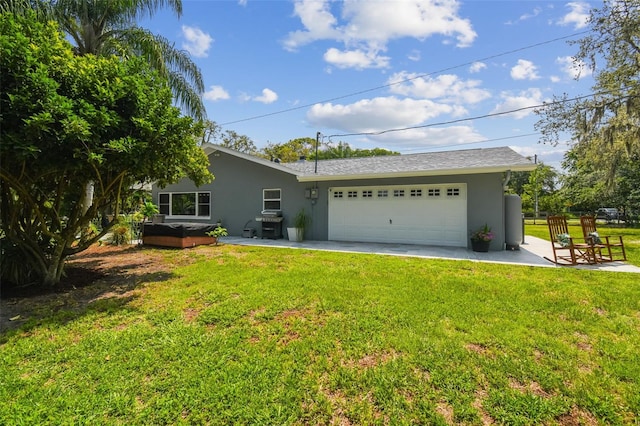 10301 Nina Ct, New Port Richey, FL 34654 - rear view of house with stucco siding, a garage, and a lawn
