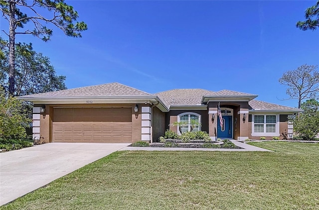 9152 Bunting Rd, Weeki Wachee, FL 34613 - single story home featuring a front lawn, a garage, driveway, and stucco siding