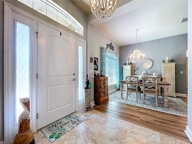 9152 Bunting Rd, Weeki Wachee, FL 34613 - foyer featuring a chandelier, baseboards, and light wood-type flooring