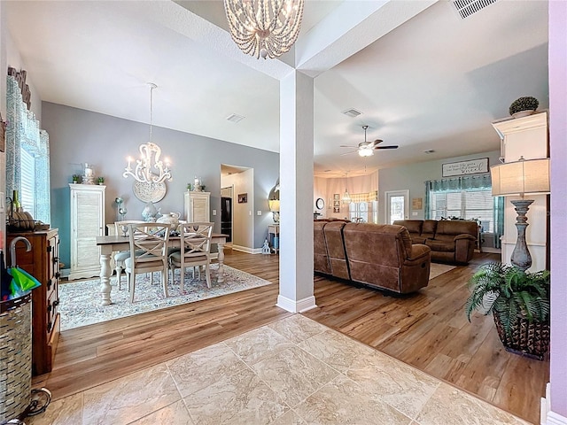 9152 Bunting Rd, Weeki Wachee, FL 34613 - dining room with a chandelier, ceiling fan, baseboards, and wood finished floors