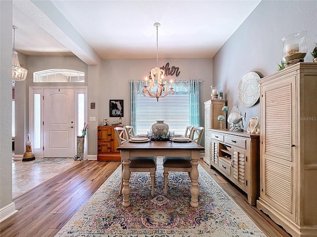 9152 Bunting Rd, Weeki Wachee, FL 34613 - dining room with a chandelier and light wood-type flooring
