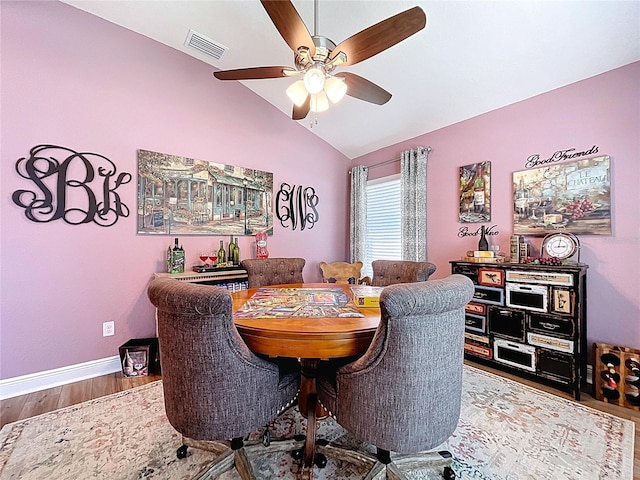 9152 Bunting Rd, Weeki Wachee, FL 34613 - dining room featuring a ceiling fan, lofted ceiling, wood finished floors, and baseboards