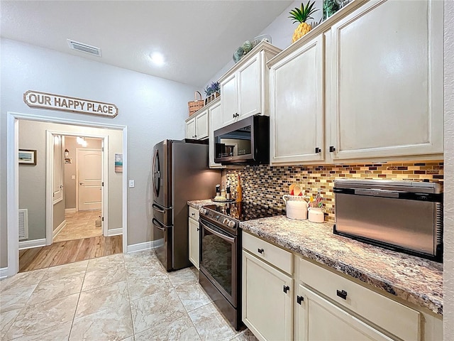 9152 Bunting Rd, Weeki Wachee, FL 34613 - kitchen featuring stainless steel appliances, decorative backsplash, light countertops, and baseboards