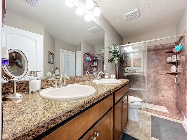 9152 Bunting Rd, Weeki Wachee, FL 34613 - full bath with a stall shower, toilet, double vanity, and a textured ceiling