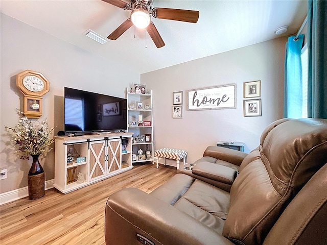 9152 Bunting Rd, Weeki Wachee, FL 34613 - living area with wood finished floors, ceiling fan, and baseboards
