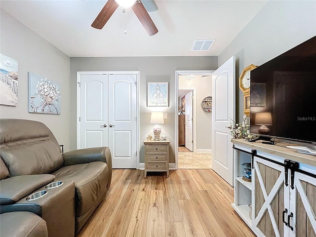 9152 Bunting Rd, Weeki Wachee, FL 34613 - living area with light wood-type flooring, ceiling fan, and baseboards