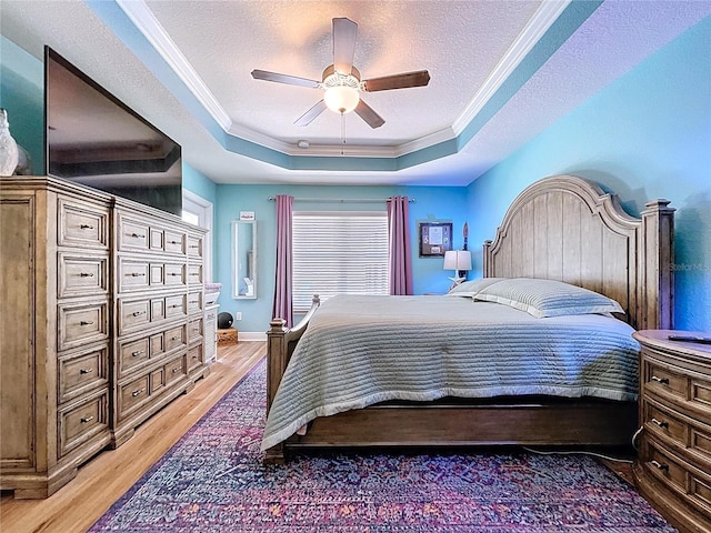 9152 Bunting Rd, Weeki Wachee, FL 34613 - bedroom with a raised ceiling, crown molding, light wood-type flooring, a textured ceiling, and ceiling fan