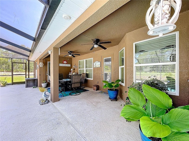 9152 Bunting Rd, Weeki Wachee, FL 34613 - view of patio / terrace featuring a ceiling fan, outdoor dining space, and glass enclosure