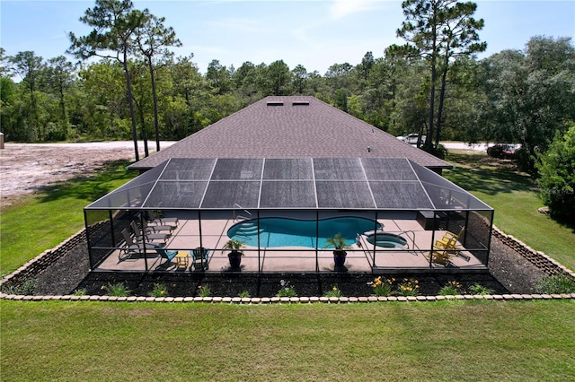 9152 Bunting Rd, Weeki Wachee, FL 34613 - view of swimming pool featuring a patio area, a yard, glass enclosure, and a pool with connected hot tub