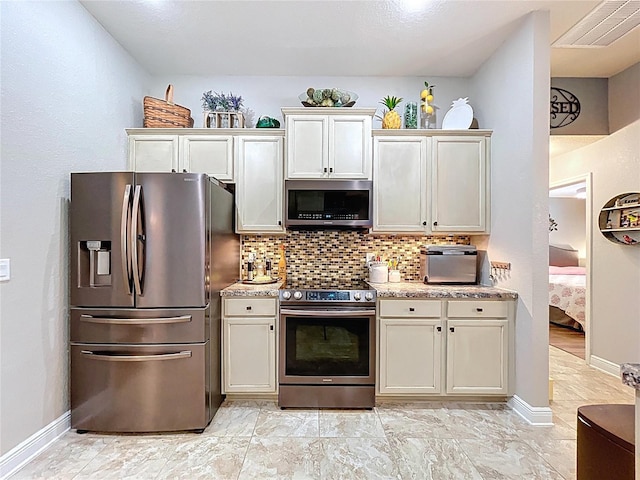9152 Bunting Rd, Weeki Wachee, FL 34613 - kitchen featuring appliances with stainless steel finishes, light countertops, backsplash, and baseboards