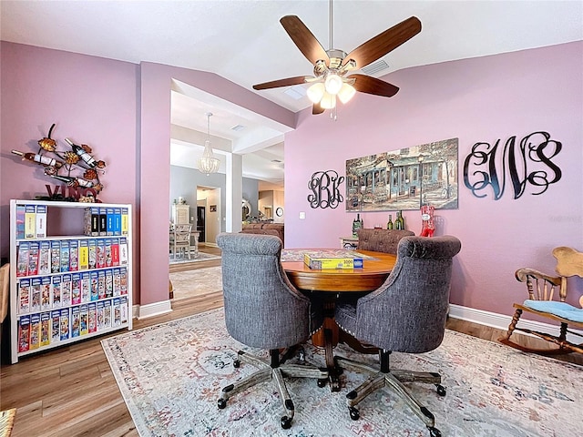 9152 Bunting Rd, Weeki Wachee, FL 34613 - dining area featuring wood finished floors, baseboards, vaulted ceiling, and ceiling fan