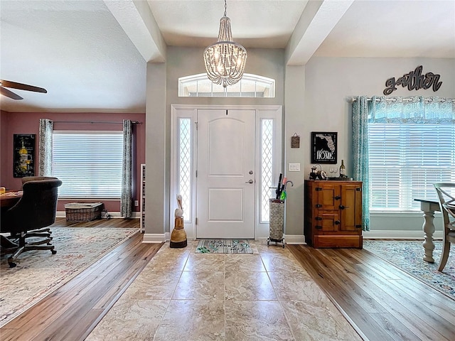 9152 Bunting Rd, Weeki Wachee, FL 34613 - entryway with plenty of natural light, baseboards, and a chandelier