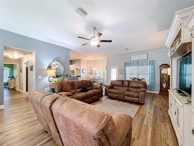 9152 Bunting Rd, Weeki Wachee, FL 34613 - living area featuring light wood finished floors, a ceiling fan, and baseboards