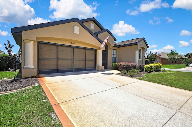 10155 Duffy Cir, Weeki Wachee, FL 34613 - view of front of house with stucco siding, concrete driveway, a garage, and a front lawn