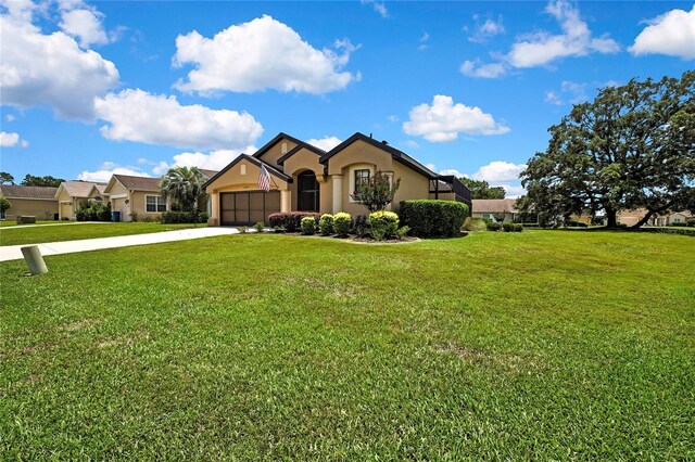 10155 Duffy Cir, Weeki Wachee, FL 34613 - view of front of property with a garage, stucco siding, driveway, and a front yard