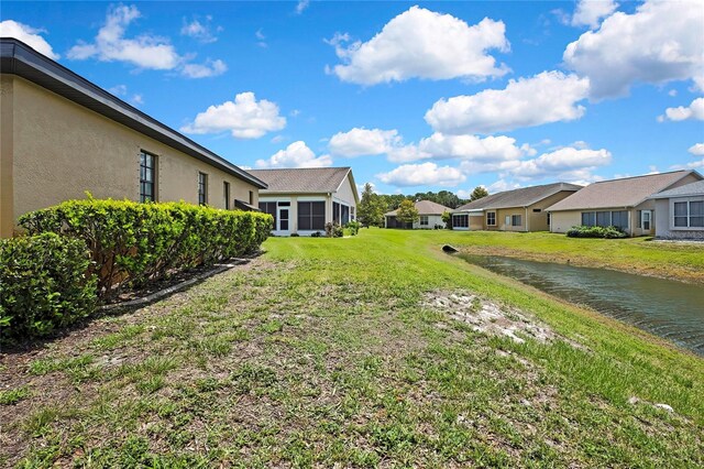 10155 Duffy Cir, Weeki Wachee, FL 34613 - view of grassy yard featuring a water view and a residential view