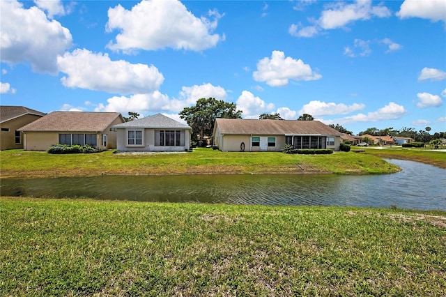 10155 Duffy Cir, Weeki Wachee, FL 34613 - rear view of house featuring a water view and a lawn