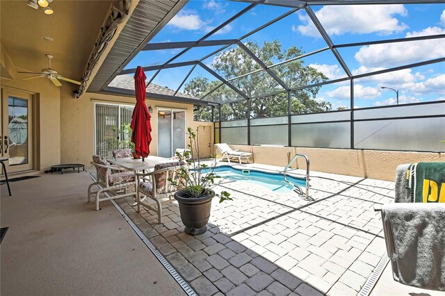 10155 Duffy Cir, Weeki Wachee, FL 34613 - view of patio with a ceiling fan, glass enclosure, and outdoor dining area