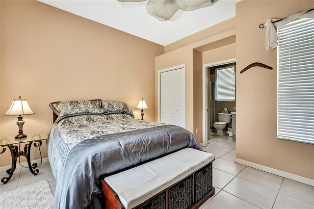10155 Duffy Cir, Weeki Wachee, FL 34613 - bedroom with light tile patterned floors, baseboards, and connected bathroom