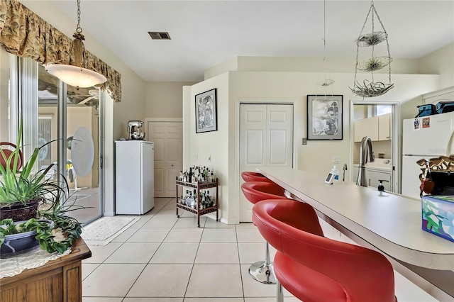 10155 Duffy Cir, Weeki Wachee, FL 34613 - office area with light tile patterned floors, a sink, and baseboards