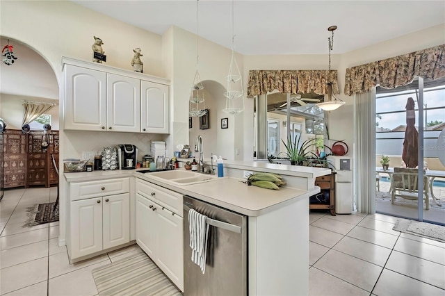 10155 Duffy Cir, Weeki Wachee, FL 34613 - kitchen with dishwasher, a sink, a peninsula, and light tile patterned flooring
