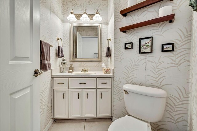 10155 Duffy Cir, Weeki Wachee, FL 34613 - half bath with wallpapered walls, vanity, toilet, and tile patterned floors