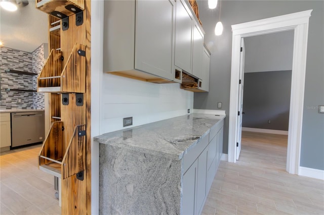 6172 Raleigh St, Spring Hill, FL 34606 - kitchen featuring stainless steel dishwasher, tasteful backsplash, light wood finished floors, and light stone countertops