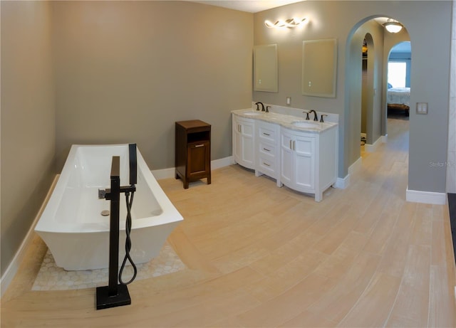 6172 Raleigh St, Spring Hill, FL 34606 - bathroom with ensuite bathroom, double vanity, a freestanding tub, and baseboards