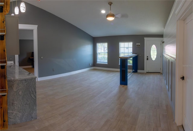 6172 Raleigh St, Spring Hill, FL 34606 - entryway with lofted ceiling, ceiling fan, light wood-style floors, and baseboards