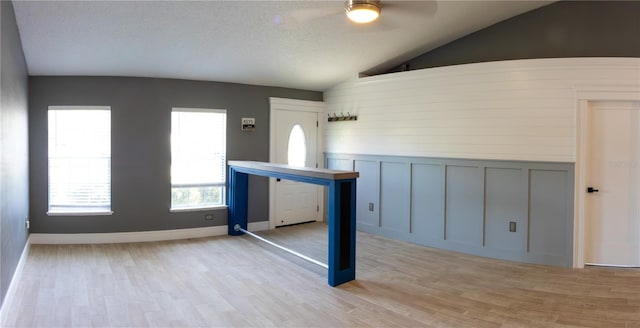 6172 Raleigh St, Spring Hill, FL 34606 - entryway featuring lofted ceiling, ceiling fan, a decorative wall, and light wood-style flooring